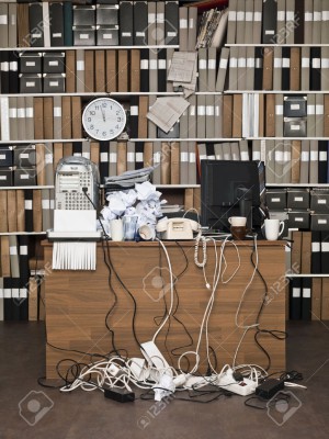 15183818-Overloaded-desk-at-a-messy-office-Stock-Photo
